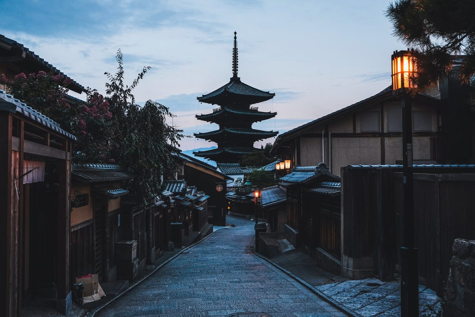 Quiet lane toward a Kyoto pagoda at dawn